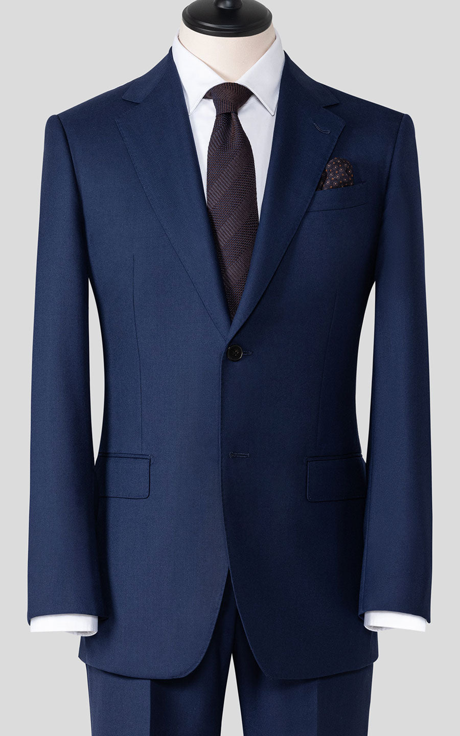 Man wearing dark blue notch lapel custom tailored suit