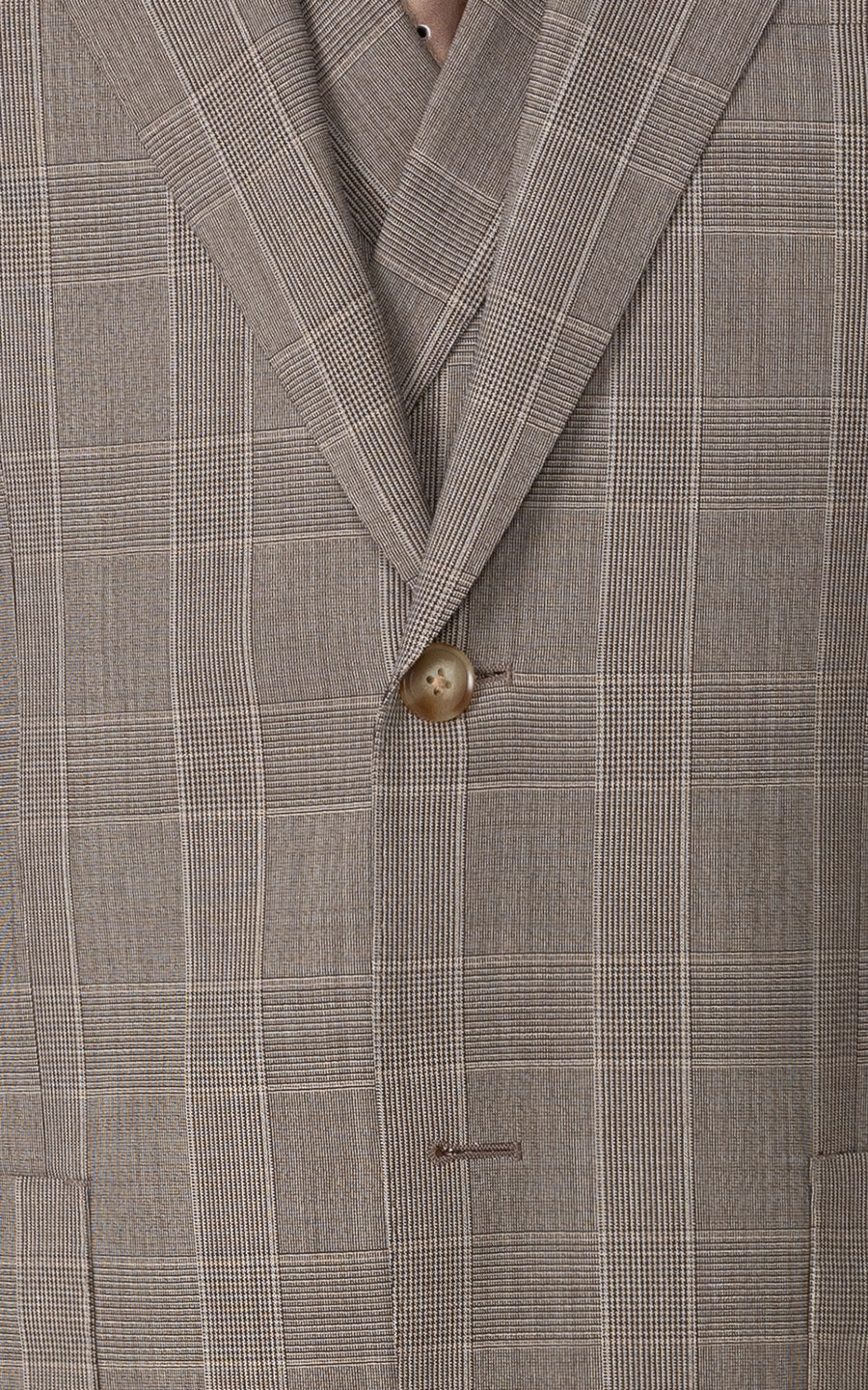 Man wearing light brown checkered bespoke tailored blazer