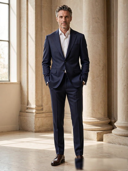 Mature model wearing a tailored navy birdseye Drago wool two-piece suit - front view