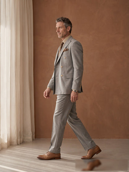 Mature model wearing a tailored grey Guabello wool double-breasted suit - side view