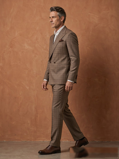 Mature model wearing a tailored brown plaid Guabello wool double-breasted suit - side view