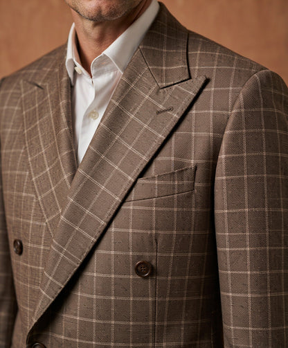 Close-up detail of brown plaid Guabello wool suiting cloth - lapel, button and weave